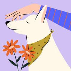 a white dog with orange flowers in it's mouth is being petted by someone