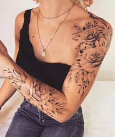 a woman with tattoos on her arms and chest