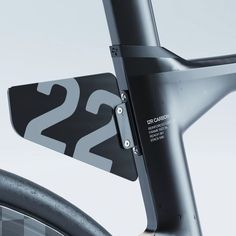 the number 22 is attached to the handlebars of a bike with a sticker on it