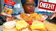 a woman sitting at a table with some food in front of her and two bags of cheez it