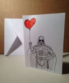 a card with a drawing of darth vader holding a heart balloon