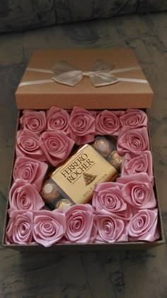 a box that has some kind of chocolate in it with roses on the front and side