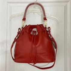 Red Flexible Leather. Gold Hardware. Removable Handle Drop 8''. Strap Drop 16''. Drawstring Closure. 2 Side Zip Pockets. Inside Zip And 2 Slip In Pockets. With Dust Bag. Size; 11” L X 7“ W X 11” H. Nwt Ora Delphine Claire Bucket Drawstring 0523420/365 C&B6 Red Shoulder Bucket Bag With Gold-tone Hardware, Red Crossbody Bucket Bag With Gold-tone Hardware, Chic Red Hobo Bag In Pouch Shape, Chic Red Hobo Pouch Bag, Red Bucket Satchel For Shopping, Red Leather Crossbody Bucket Bag, Red Bucket Satchel With Adjustable Strap, Red Bucket Bag With Detachable Strap, Red Bucket Hobo Bag For Everyday