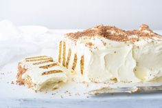 a piece of cake with white frosting and gold sprinkles