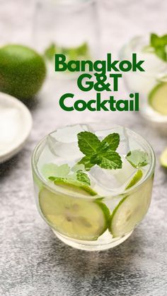 a glass filled with ice and limes on top of a table