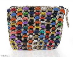 a multicolored woven purse with buttons on the front and side, sitting on a white surface