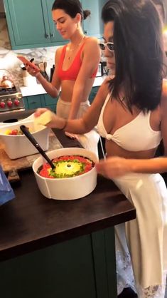 two women in the kitchen preparing food together