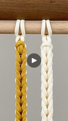 three different colored ropes hanging from a wooden pole