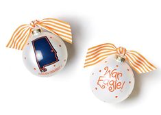 two christmas ornaments with orange and white stripes on them, one has an ornament in the shape of a map