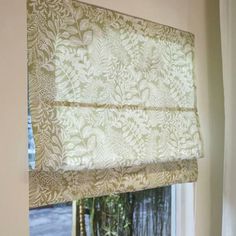 an open window with a roman blind in front of it