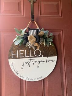 a welcome sign hanging on the front door of a house that says hello just for you know