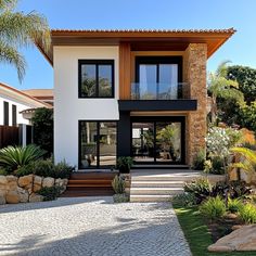 a modern house with stone steps leading to the front door