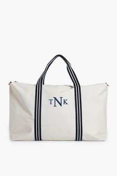 White and Navy Coated Canvas Weekender White Weekender Bag With Adjustable Strap For Travel, Chic White Rectangular Weekender Bag, Chic Rectangular Travel Bag For Weekend Trips, Chic Weekender Bag With Dust Bag For Travel, Chic Weekender Bag For Travel, Chic Travel Weekender Bag With Dust Bag, Classic Summer Vacation Bags, Elegant Weekend Tote Duffle Bag, Elegant Weekender Tote Bag For Weekend Trips