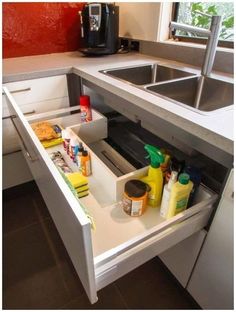 an open drawer in the middle of a kitchen counter