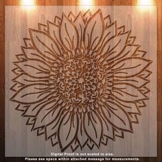 a wooden wall hanging with lights around it and a sunflower design on the wall