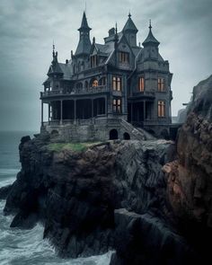 an old house sitting on top of a cliff next to the ocean