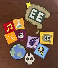 various patches and magnets are arranged on a brown surface, including an ef sign