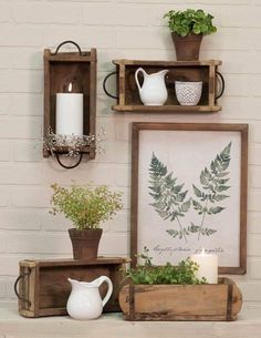 three wooden shelves with plants and candles on them, one holding a candle holder the other displaying greenery