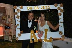 a bride and groom posing for a photo with the word al in front of them