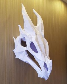 a paper sculpture of a dragon's head on a wall