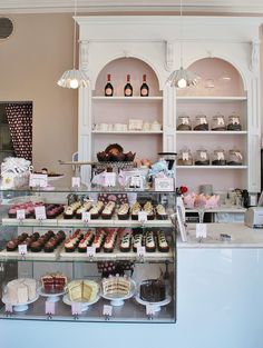 a bakery filled with lots of cakes and cupcakes