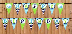 happy birthday banner with blue and green chevrons on wooden fence background, ready to be used for party decorations