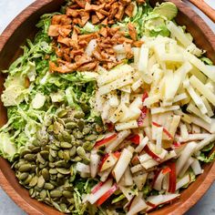 a wooden bowl filled with different types of food