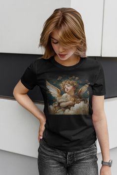 Trending Cherub baby Angel renaissance graphic Unisex Softstyle T-Shirt, praying, chatolic style, christian, faith, angel gifts, angele tee tshirt aesthetic, aesthetic tshirt girls, aesthetic graphic tshirt, aesthetic oversized tshirt, Christian aesthetic t-shirt, angel aesthetic, graphic t-shirt aesthetic, cottagecore aesthetic t-shirt,  oversized tee aesthetic, The unisex soft-style t-shirt puts a new spin on casual comfort. Made from very soft materials, this tee is 100% cotton for solid colors. Heather colors and sports grey include polyester. The shoulders have twill tape for improved durability. There are no side seams. The collar is made with ribbed knitting to prevent curling damage.  .: 100% ring-spun cotton (fiber content may vary for different colors) .: Light fabric (4.5 oz/yd² Shibuya Style, Gothic Tees, Cherub Baby, Cherub Angel, Angel Gifts, Angel Painting, Aesthetic T Shirts, Baby Angel, Gothic Fashion