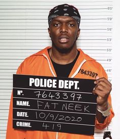 a man in an orange prison uniform holding up a sign that says police dept,