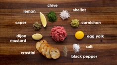 an assortment of different foods on a wooden table with words describing them in english and spanish