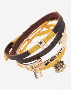 Officially licensed Includes: 4 Bracelets Material: Zinc alloy, polyurethane, glass Lobster claw closure Jewelry Care: Wipe clean or use Spencer's Jewelry Wipes Imported Note: Do not use any harsh, alcohol-based chemicals as this may cause tarnishing This is a decorative item and should not be worn to sleep Hufflepuff Jewelry, Harry Potter Hufflepuff, Dark Academia Fashion, Academia Fashion, Dark Academia, To Sleep, Lobster Claw, Jewelry Care, Bracelet Set