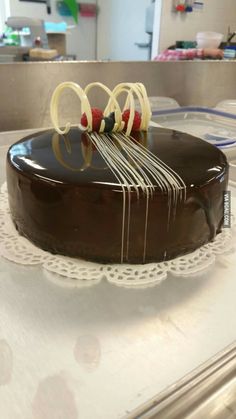 a chocolate cake sitting on top of a white doily