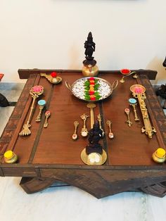 a wooden table topped with lots of different types of utensils and spoons