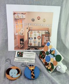 a baby's room with an elephant, giraffe and bear keychain