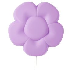 a purple flower shaped lollipop on a stick