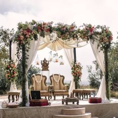 an outdoor wedding setup with chairs and flowers