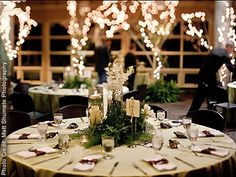 the tables are set with candles and centerpieces