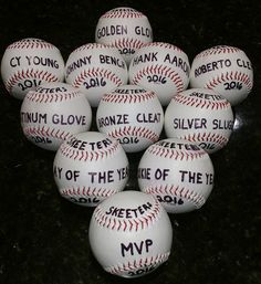 a bunch of baseballs that have been placed on the ground with words written on them