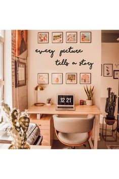 a desk with a laptop computer on top of it next to a potted cactus