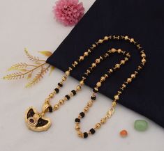 Om Excellent Design Gold Plated Rudraksha Mala With Pendant DESCRIPTION :-  Mala Dimension Height:63 cm (24.8 inch) Width:6 mm (0.6 cm) Depth:6 mm (0.6 cm) Pendant Dimension Height:25 cm (9.84 inch) Width:36 mm (3.6 cm) Depth:13 mm (1.3 cm) Other Specification Weight:30 Gram Size:Fixed Lock Type:S Hook Color:Golden, Black Material:Brass, Diamond, Rudraksha Surface Finish:Shining, Textured Occasion:Festival, Marriage / Wedding / Engagement, Birthday, Gift, Photography, Religious/Temple Style of Jewellery:Religious, Handmade, Filigree Design, Rajwadi, Sophisticated, Exciting Symbol:Aum, OM, Damroo Ideal For:Men Sales Package:1 Mala + 1 Pendant Gold Rudraksha Mala, Gold Rudraksha, Rudraksh Mala, Jewellery Making Tools, Gold Finger Rings, Gift Photography, Rudraksha Mala, Boys Jewelry, Antique Gold Jewelry