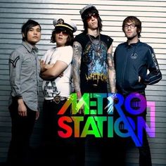 three men standing next to each other in front of a garage door with the words metro station shake it