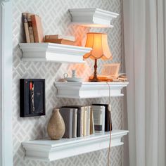 some white shelves with books and lamps on them