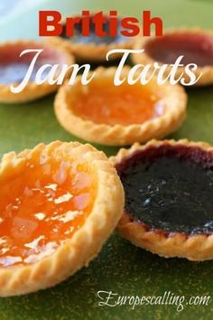 small jam tarts on a green plate with the words british jam tarts above them