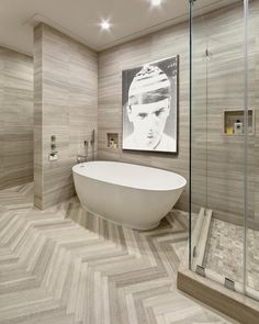 a bathroom with a tub, sink and large painting on the wall in it's corner