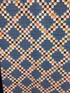 a blue quilt with multicolored squares on it