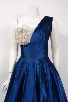 For Sale on 1stDibs - Fashioned from vibrant sapphire blue mid weight silk-organza, this 1950's Beaumelle creation has everything a woman wants. The bodice has a gorgeous ruched Blue Evening Dress With Boned Bodice For Formal Occasions, Blue Evening Dress With Boned Bodice For Formal Events, Blue Evening Dress With Boned Bodice, Vintage Silk Evening Dress With Fitted Bodice, Blue Silk Evening Dress With Pleated Bodice, Blue Cocktail Evening Dress With Pleated Bodice, Vintage Cocktail Dress With Boned Bodice, Vintage Silk Evening Dress, Silk Vintage Evening Dress For Vintage Events