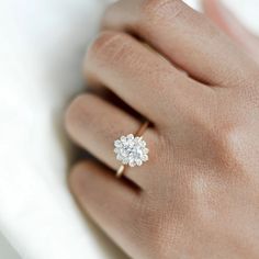 a woman's hand with a diamond ring on it