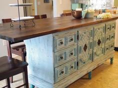 an old dresser is painted blue and has flowers on it