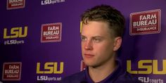 a man standing in front of a purple wall