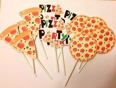 pizza party cupcakes and lollipop sticks are arranged on a white surface